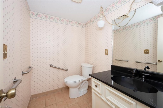 half bathroom featuring tile patterned floors, vanity, and toilet