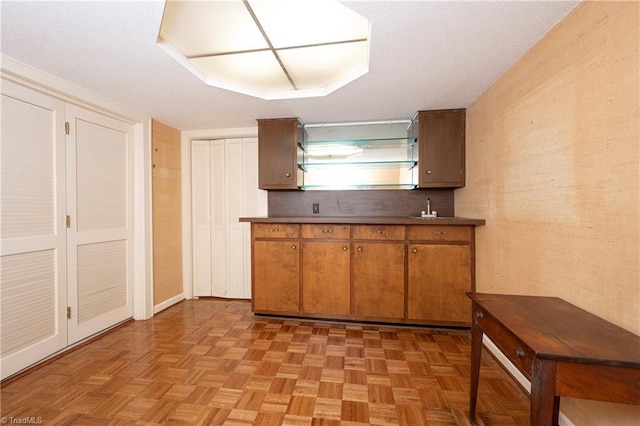 kitchen with brown cabinets and dark countertops