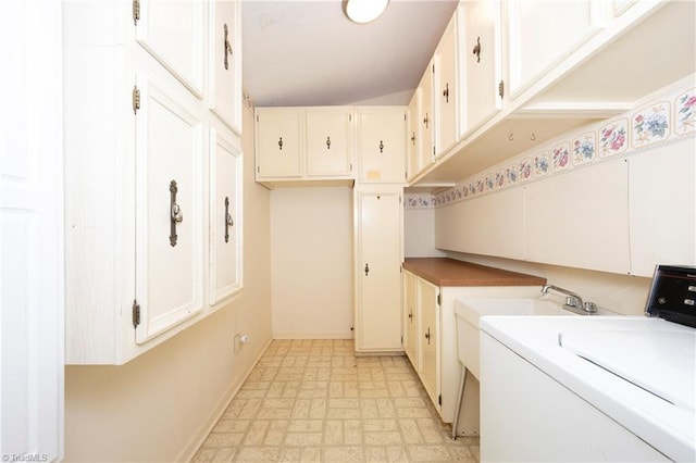 laundry room featuring baseboards, cabinet space, and washer / clothes dryer