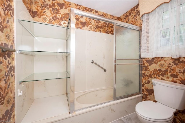 bathroom with shower / bath combination with glass door, toilet, and wallpapered walls