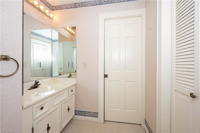 bathroom featuring vanity and baseboards