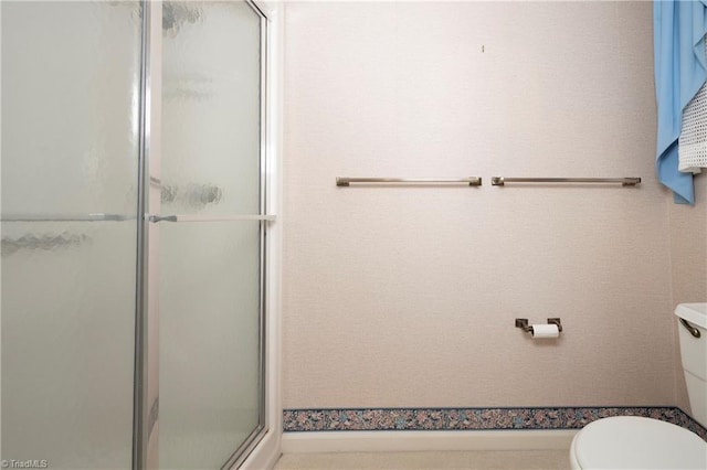 full bathroom with toilet and a stall shower