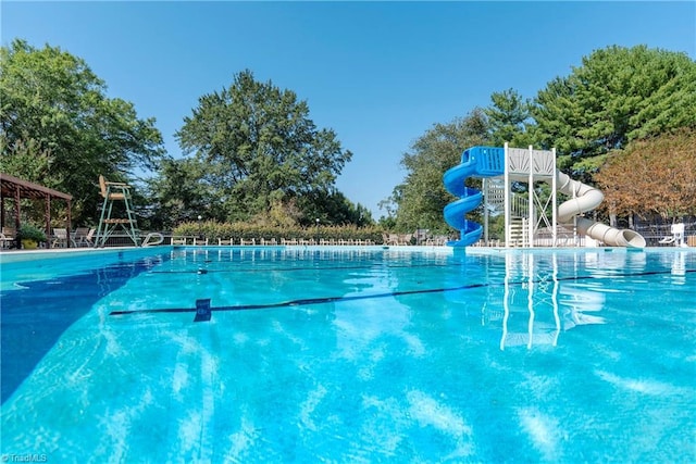 community pool featuring a water slide