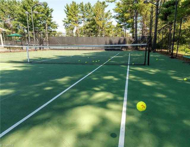 view of sport court featuring fence