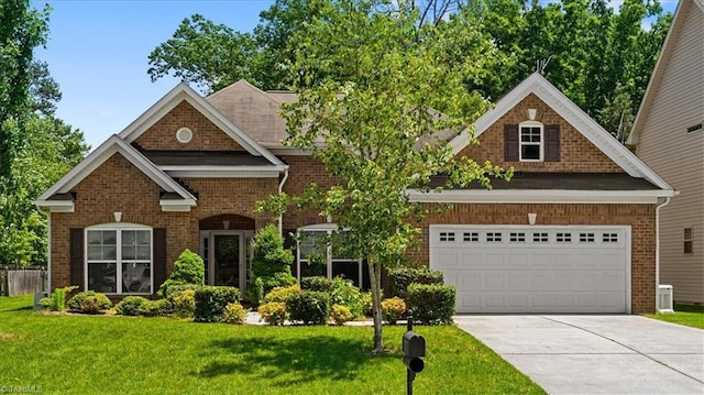 2230 Dunning Ct, High Point, NC 27265 - view of front of house with brick siding, a front lawn, driveway, and central air condition unit