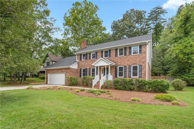 4105 Oak Hollow Dr, High Point, NC 27265 - colonial-style house featuring a chimney, driveway, an attached garage, and brick siding