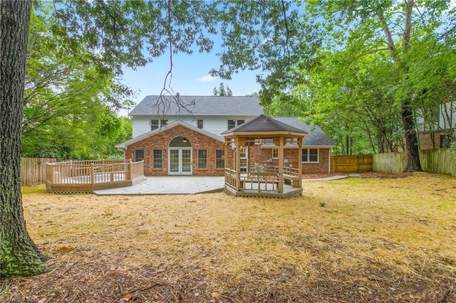 4105 Oak Hollow Dr, High Point, NC 27265 - back of house featuring french doors, brick siding, a deck, and a fenced backyard