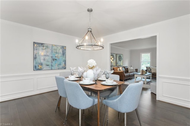 4105 Oak Hollow Dr, High Point, NC 27265 - dining space with a chandelier, crown molding, dark wood finished floors, a decorative wall, and a wainscoted wall