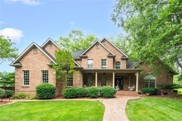 7672 Crossing Ridge Dr, Belews Creek, NC 27009 - craftsman inspired home featuring covered porch, brick siding, and a front lawn
