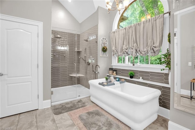 7672 Crossing Ridge Dr, Belews Creek, NC 27009 - full bath with a shower stall, lofted ceiling, a soaking tub, a chandelier, and tile patterned floors