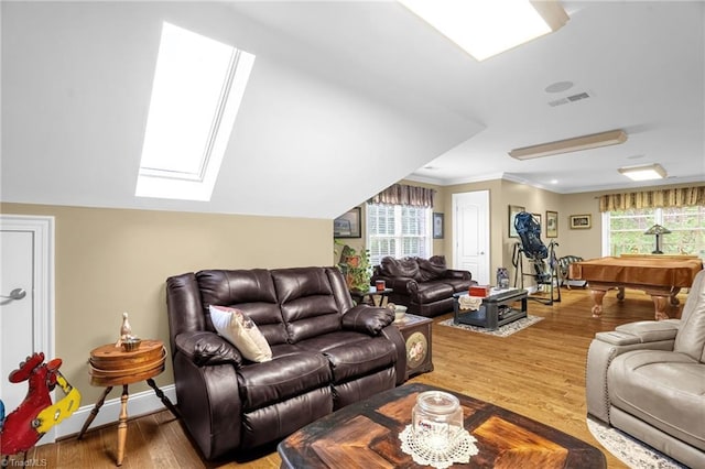 7672 Crossing Ridge Dr, Belews Creek, NC 27009 - living area featuring a skylight, wood finished floors, and crown molding