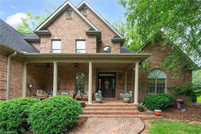 7672 Crossing Ridge Dr, Belews Creek, NC 27009 - view of exterior entry with brick siding, a ceiling fan, and covered porch