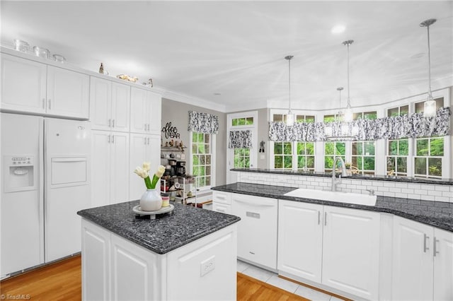 7672 Crossing Ridge Dr, Belews Creek, NC 27009 - kitchen with white appliances, ornamental molding, white cabinets, a kitchen island, and hanging light fixtures