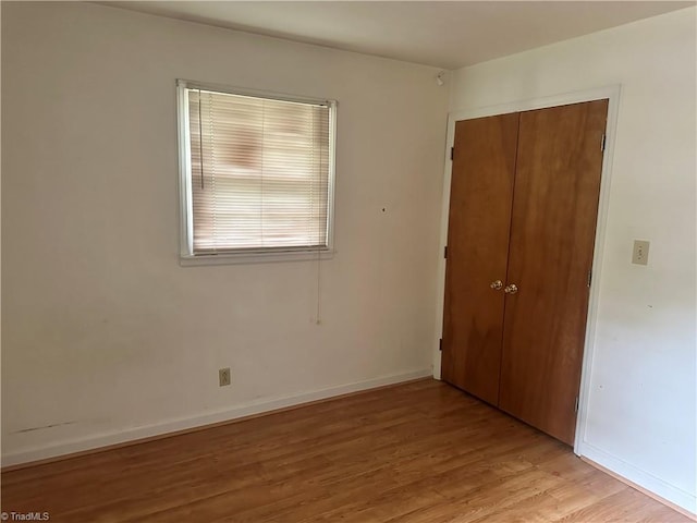 3815 Sheridan Rd, Greensboro, NC 27455 - unfurnished bedroom featuring light wood finished floors, a closet, and baseboards
