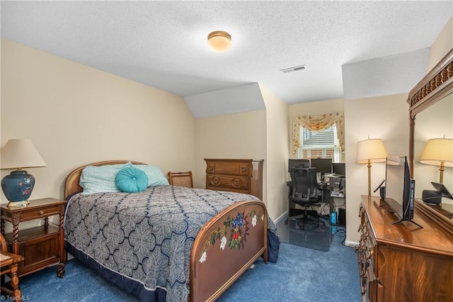 bedroom with a textured ceiling, carpet, and vaulted ceiling