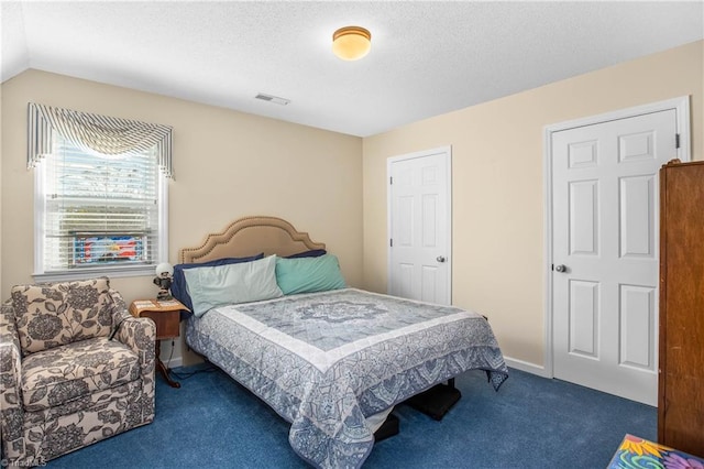 carpeted bedroom featuring a textured ceiling and vaulted ceiling