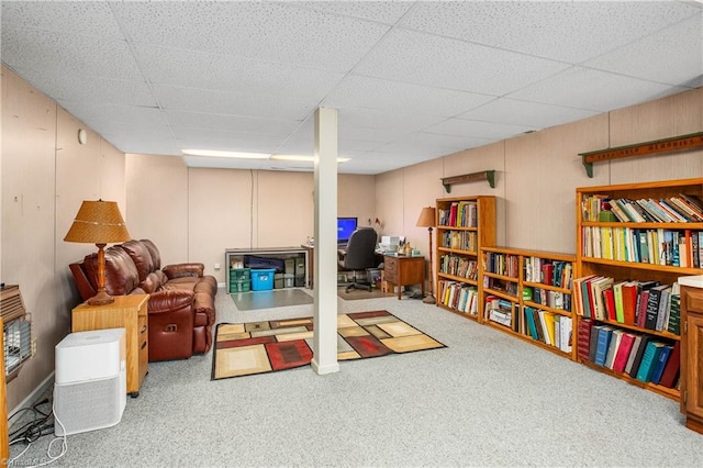 interior space featuring carpet flooring and a drop ceiling