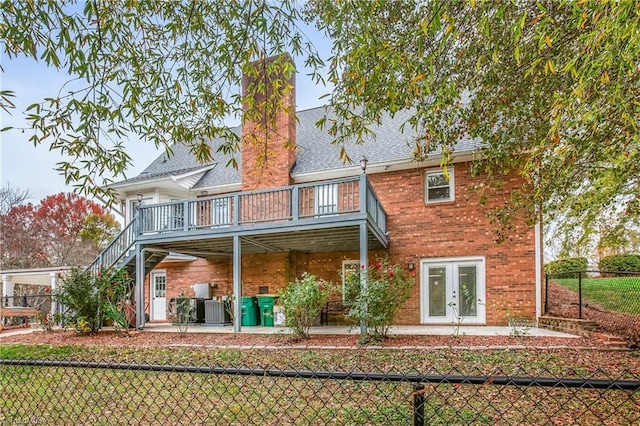 rear view of house with french doors, a balcony, a deck, and central air condition unit