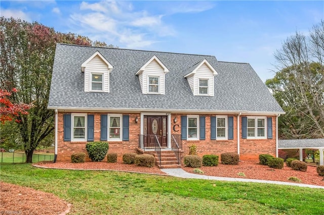 cape cod home with a front lawn