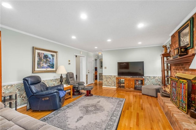 living room with hardwood / wood-style flooring, a brick fireplace, and ornamental molding