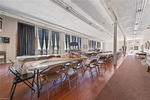 dining room with plenty of natural light and dark hardwood / wood-style floors