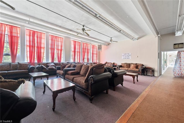 living room featuring carpet floors, ceiling fan, and plenty of natural light