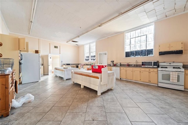 kitchen featuring crown molding, sink, white appliances, and light tile patterned floors