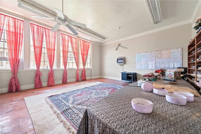 living room featuring crown molding, hardwood / wood-style floors, and ceiling fan