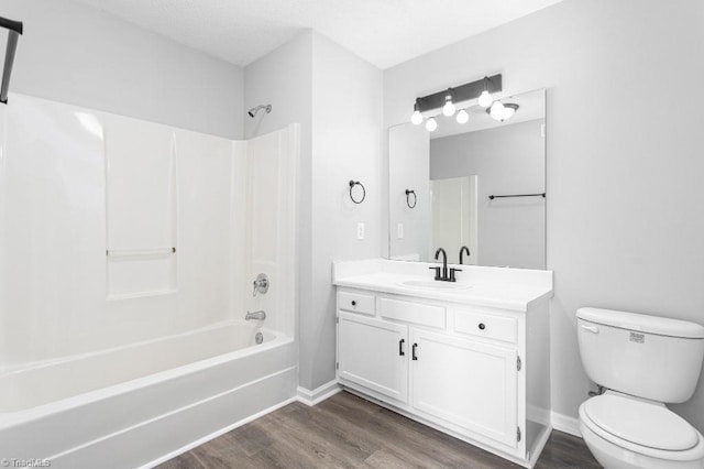 full bathroom featuring toilet, bathtub / shower combination, vanity, and hardwood / wood-style flooring