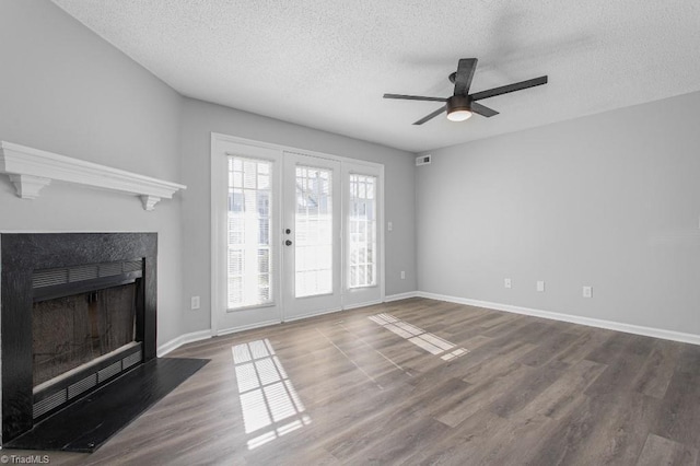 unfurnished living room featuring ceiling fan, a textured ceiling, and hardwood / wood-style flooring