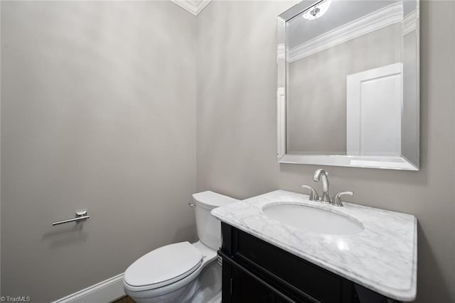 bathroom featuring vanity, ornamental molding, and toilet