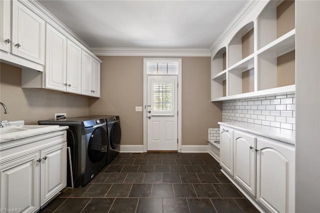 laundry room featuring cabinets, crown molding, sink, and independent washer and dryer