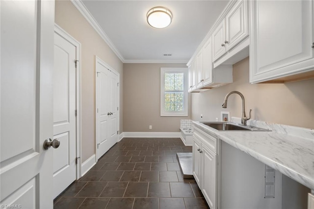 kitchen featuring sink, crown molding, dark tile patterned floors, light stone countertops, and white cabinets