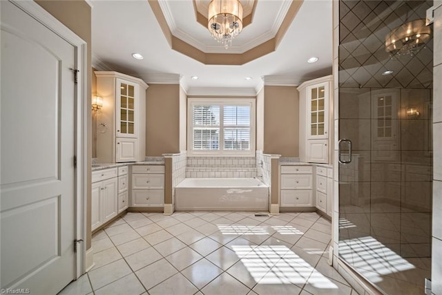 bathroom featuring shower with separate bathtub, a chandelier, ornamental molding, vanity, and a raised ceiling