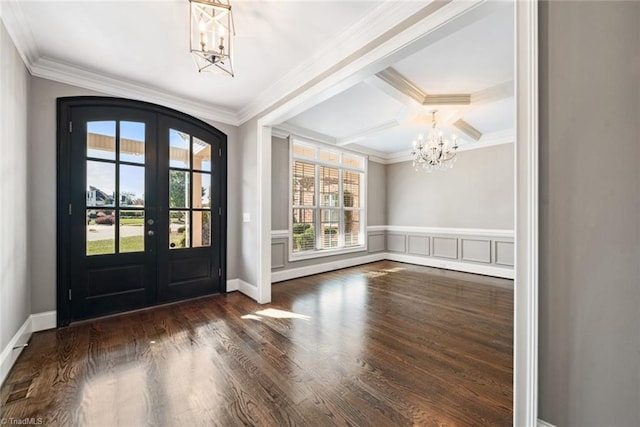 foyer entrance with beamed ceiling, french doors, a healthy amount of sunlight, and dark hardwood / wood-style flooring