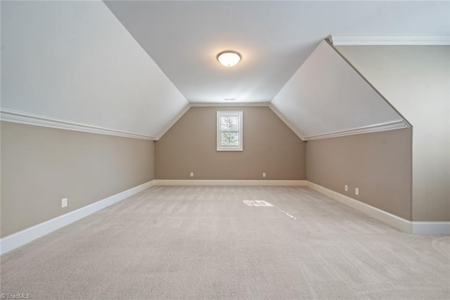 bonus room with light carpet and vaulted ceiling