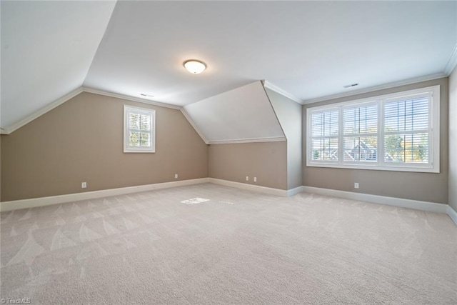 bonus room with vaulted ceiling and light colored carpet