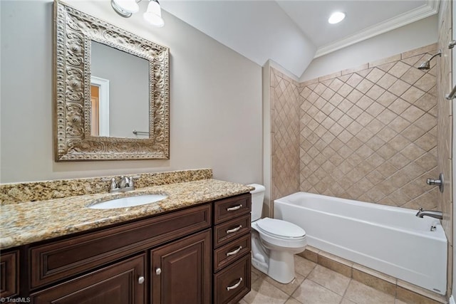 full bathroom with tile patterned flooring, tiled shower / bath, vanity, and toilet