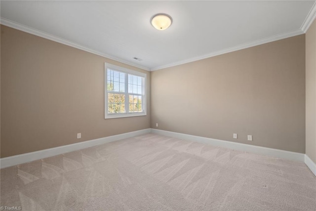 unfurnished room with ornamental molding and light colored carpet