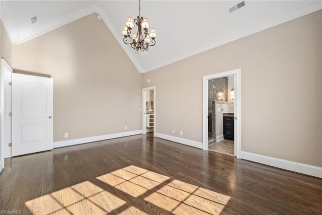 unfurnished living room featuring an inviting chandelier, high vaulted ceiling, dark wood-type flooring, and ornamental molding