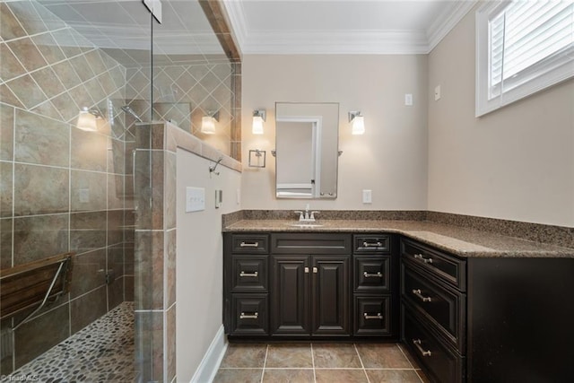 bathroom with ornamental molding, tile patterned floors, tiled shower, and vanity