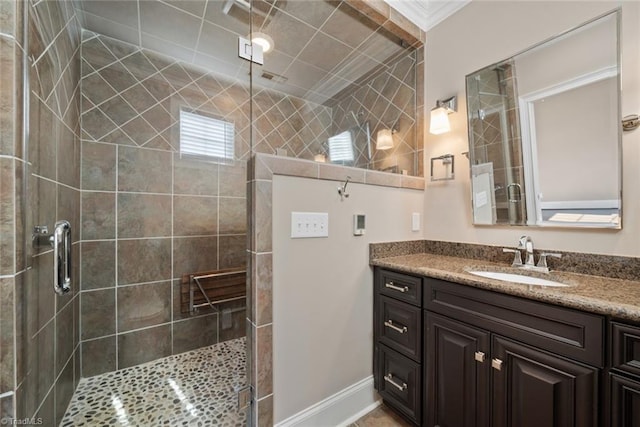 bathroom with vanity and a shower with door