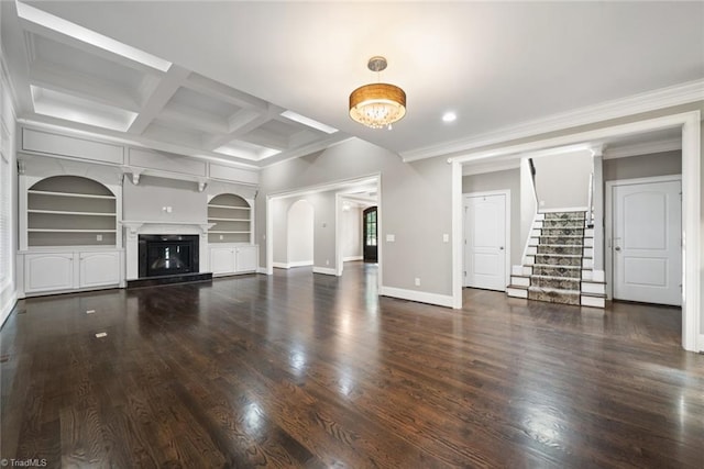 unfurnished living room with built in shelves, coffered ceiling, ornamental molding, dark hardwood / wood-style floors, and beam ceiling