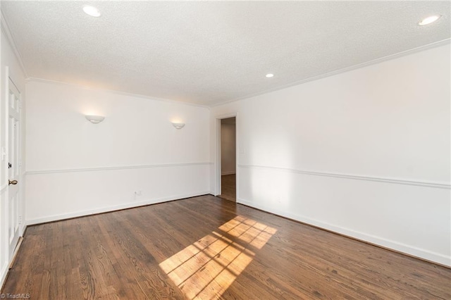 empty room featuring crown molding, dark hardwood / wood-style flooring, and a textured ceiling