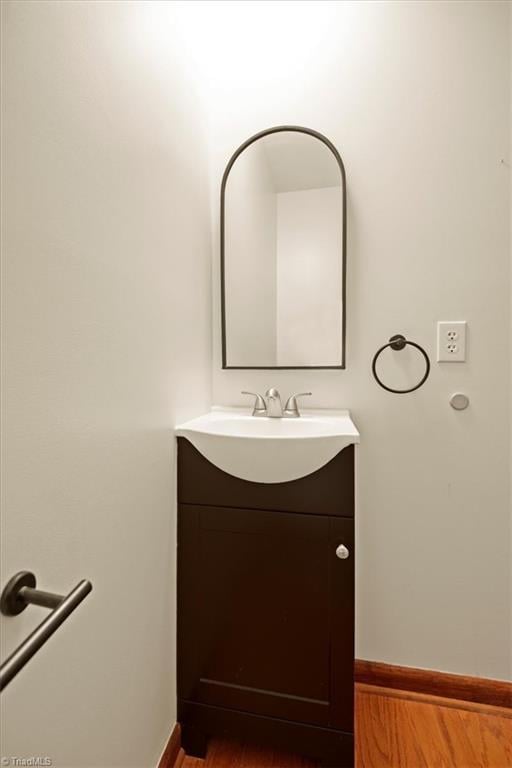 bathroom featuring hardwood / wood-style flooring and vanity