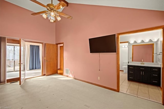 unfurnished bedroom with ensuite bath, beamed ceiling, access to outside, ceiling fan, and light colored carpet