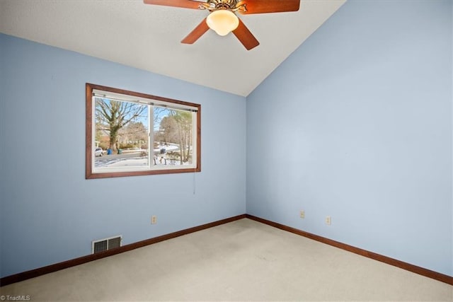 spare room with lofted ceiling, ceiling fan, and carpet