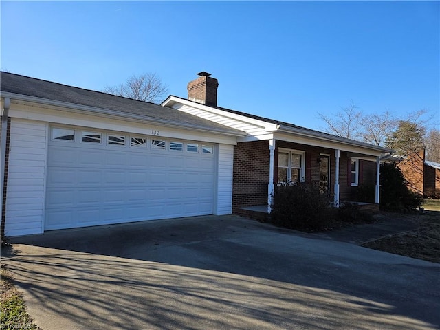 ranch-style home featuring a garage and a porch