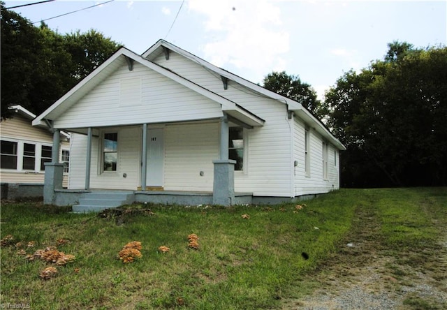 bungalow-style home with a front yard and a porch