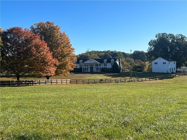 view of yard featuring a rural view and fence